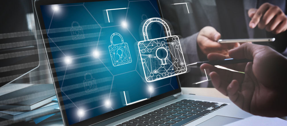 A person securing their laptop with antivirus software